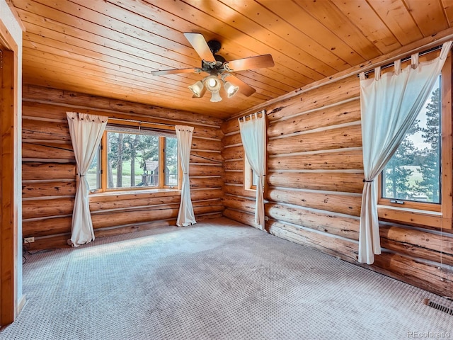 carpeted empty room featuring wood ceiling, ceiling fan, and rustic walls