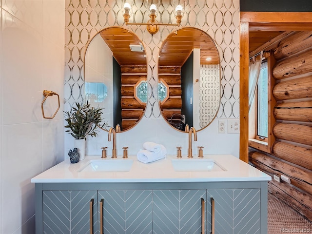 bathroom with vanity, plenty of natural light, wooden ceiling, and rustic walls