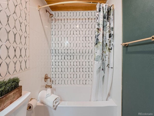 bathroom featuring shower / bath combo and toilet