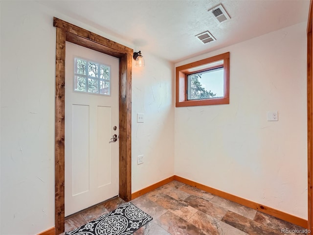 entryway with a textured ceiling