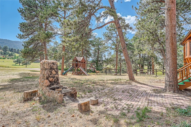 view of yard featuring a mountain view and a playground