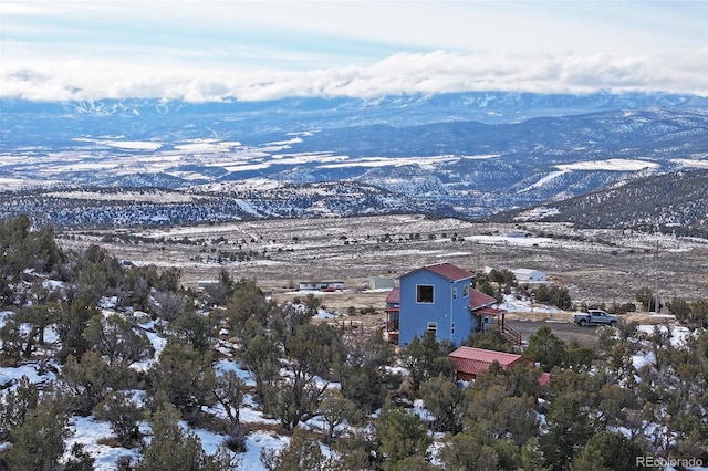 snowy aerial view with a mountain view