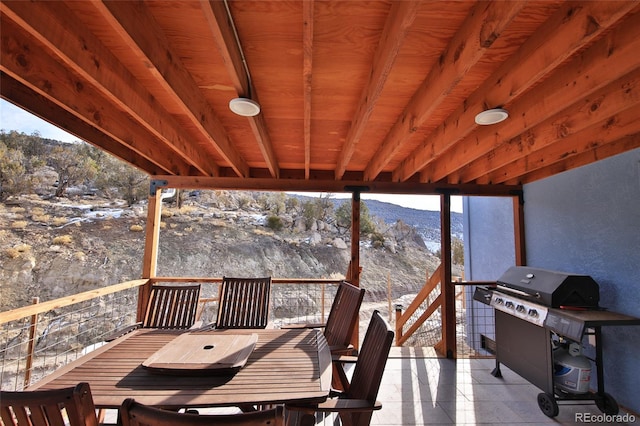 snow covered deck with a mountain view