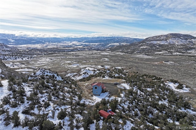 snowy aerial view with a mountain view