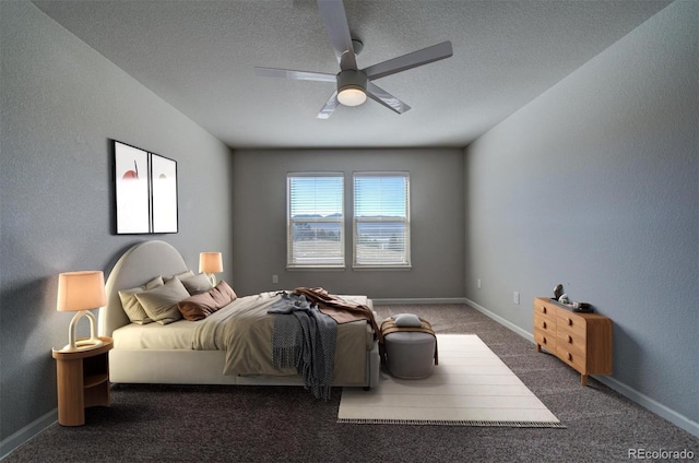 bedroom with dark colored carpet, a textured ceiling, and ceiling fan