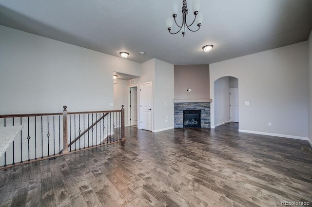 unfurnished living room featuring a stone fireplace and hardwood / wood-style floors