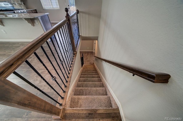 stairs with hardwood / wood-style floors