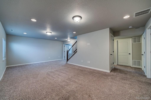 basement with a textured ceiling and carpet