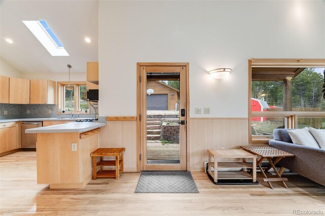 1002 County Road 99, Black Hawk, CO 80422 - kitchen with stainless steel appliances, light brown cabinets, a skylight, wainscoting, and a peninsula