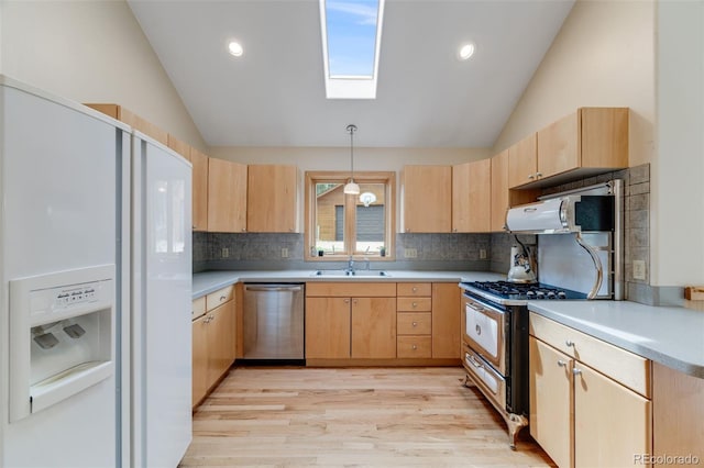 1002 County Road 99, Black Hawk, CO 80422 - kitchen with stainless steel appliances, light brown cabinets, vaulted ceiling, a sink, and a skylight