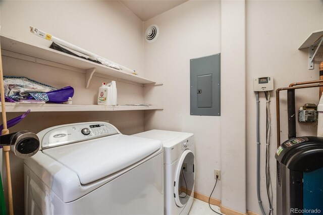 1002 County Road 99, Black Hawk, CO 80422 - laundry area with electric panel, washing machine and dryer, and baseboards