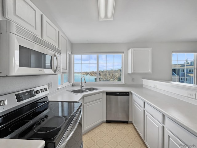 kitchen with white cabinetry, plenty of natural light, sink, and appliances with stainless steel finishes