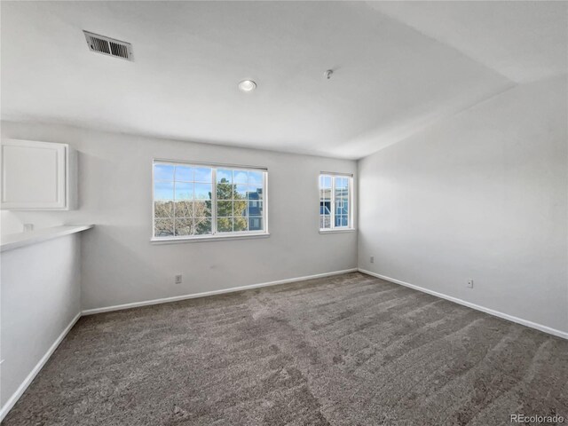 6850 Xavier Cir Unit 12, Westminster, CO 80030 - unfurnished room featuring dark colored carpet, baseboards, lofted ceiling, and recessed lighting