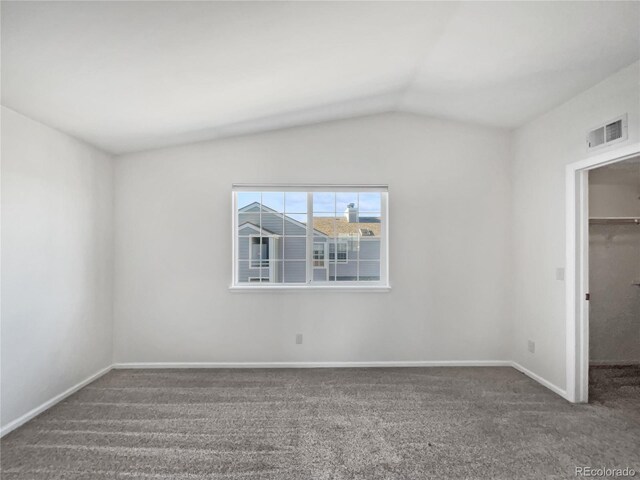 6850 Xavier Cir Unit 12, Westminster, CO 80030 - unfurnished bedroom with a spacious closet, lofted ceiling, carpet, a closet, and baseboards