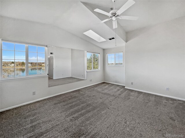 6850 Xavier Cir Unit 12, Westminster, CO 80030 - unfurnished room featuring a skylight, dark carpet, lofted ceiling, a ceiling fan, and baseboards