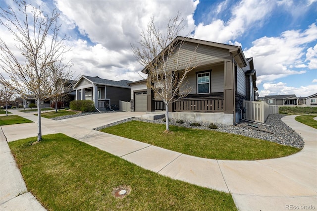 10595 Boston St, Commerce City, CO 80640 - view of front facade with driveway, an attached garage, and a porch