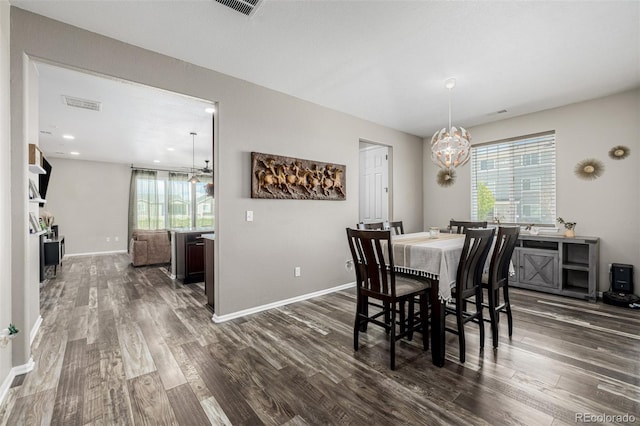 10595 Boston St, Commerce City, CO 80640 - dining area featuring a chandelier, dark wood-type flooring, and baseboards