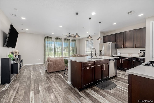 10595 Boston St, Commerce City, CO 80640 - kitchen with a sink, appliances with stainless steel finishes, light countertops, light wood-style flooring, and recessed lighting