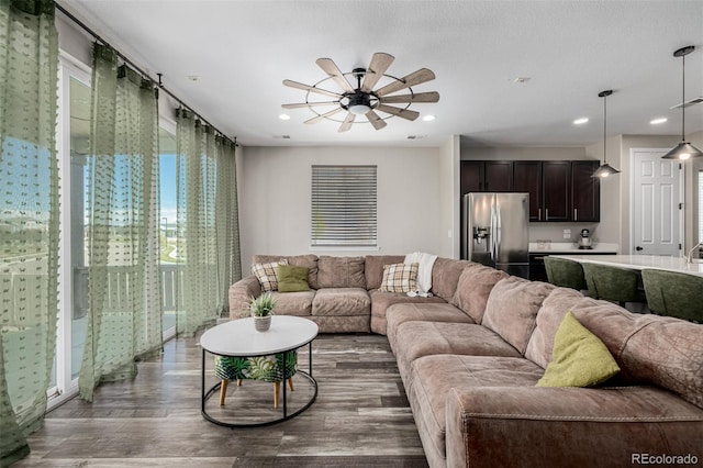 10595 Boston St, Commerce City, CO 80640 - living room with dark wood-type flooring, ceiling fan, and recessed lighting