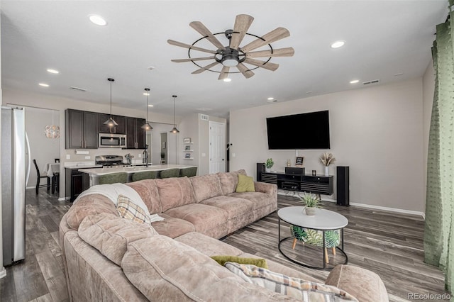 10595 Boston St, Commerce City, CO 80640 - living area featuring ceiling fan, wood finished floors, recessed lighting, and baseboards