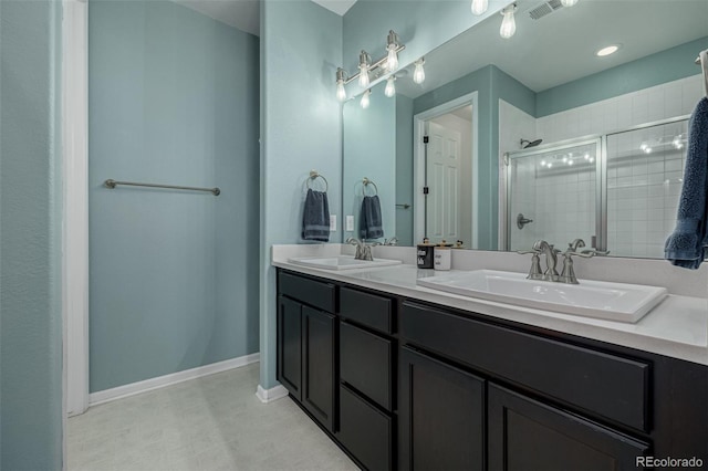 10595 Boston St, Commerce City, CO 80640 - full bathroom featuring a shower stall, double vanity, and baseboards