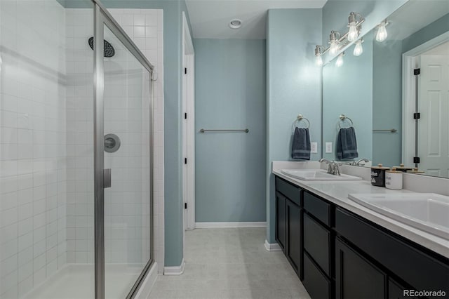 10595 Boston St, Commerce City, CO 80640 - bathroom with a stall shower, baseboards, double vanity, and tile patterned floors