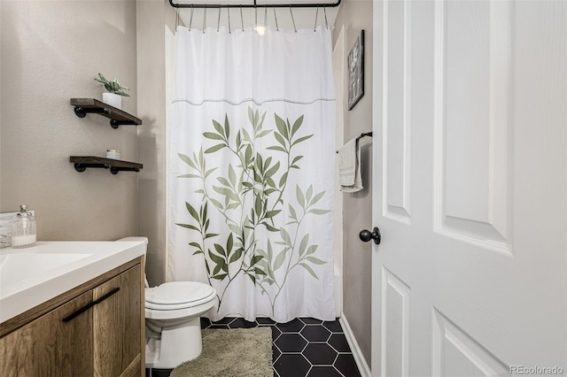 10595 Boston St, Commerce City, CO 80640 - bathroom with toilet, vanity, and tile patterned flooring