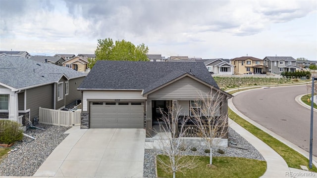 10595 Boston St, Commerce City, CO 80640 - view of front facade with a residential view, a garage, driveway, a shingled roof, and covered porch