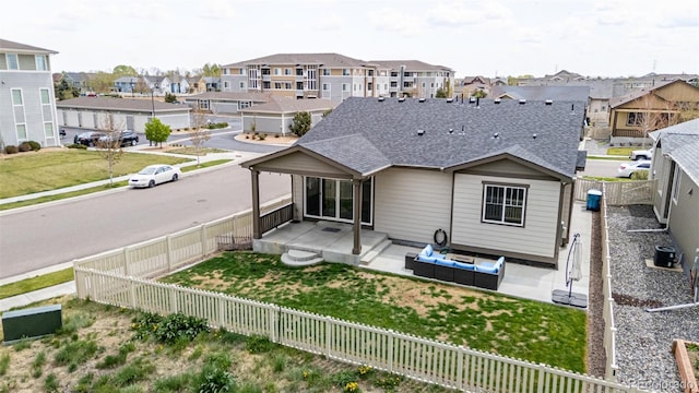 10595 Boston St, Commerce City, CO 80640 - back of house featuring a residential view, a patio, a shingled roof, and an outdoor hangout area