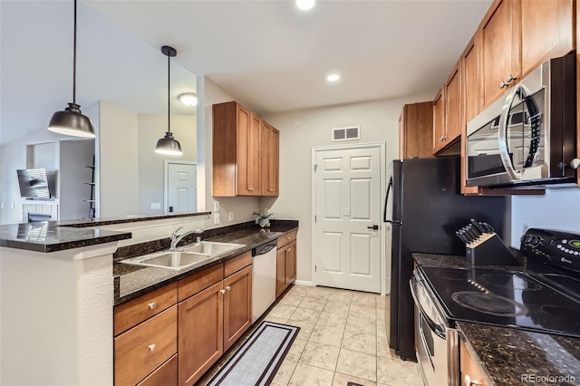 kitchen featuring pendant lighting, stainless steel appliances, dark stone counters, sink, and light tile patterned floors