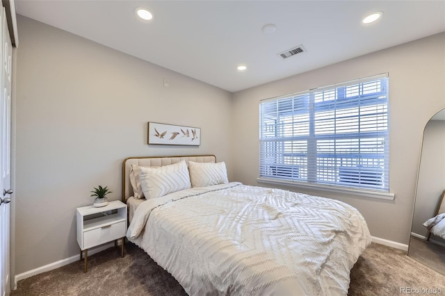 bedroom with dark colored carpet