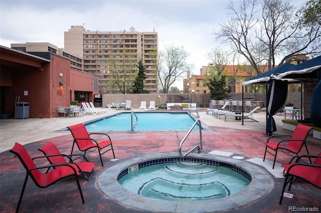 view of pool featuring a community hot tub and a patio