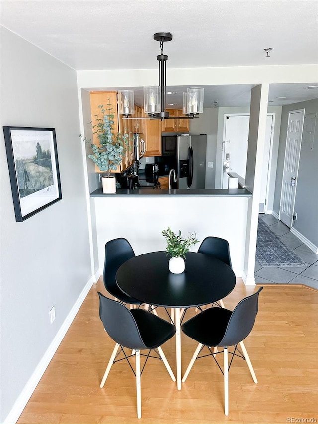 dining area featuring a chandelier and light hardwood / wood-style flooring