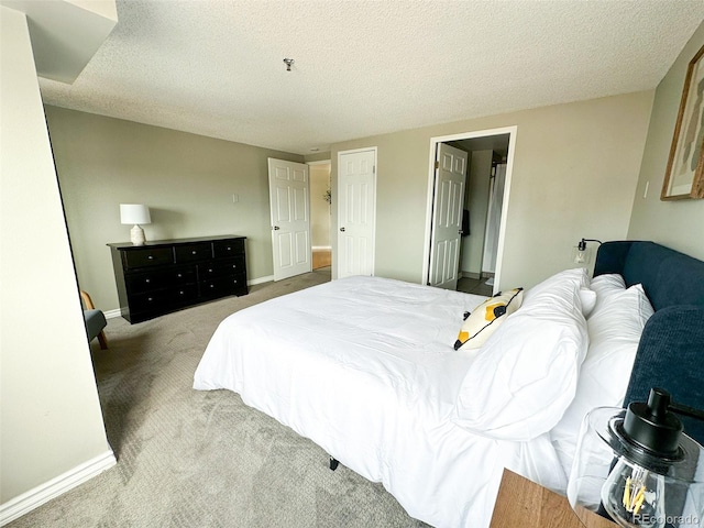 carpeted bedroom with a textured ceiling