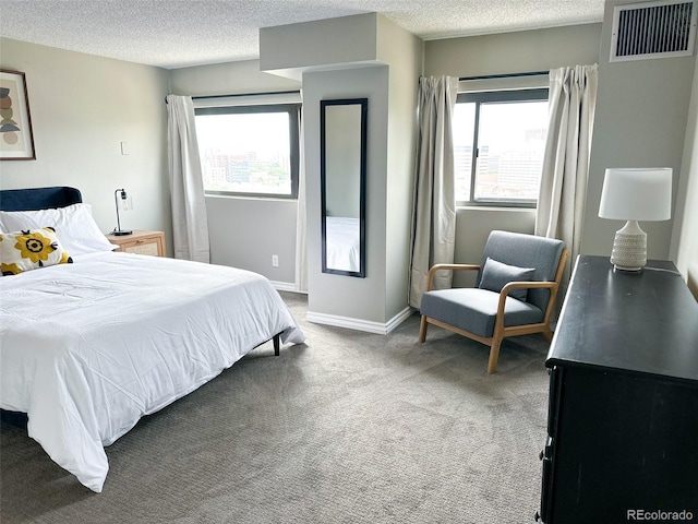 bedroom with carpet and a textured ceiling