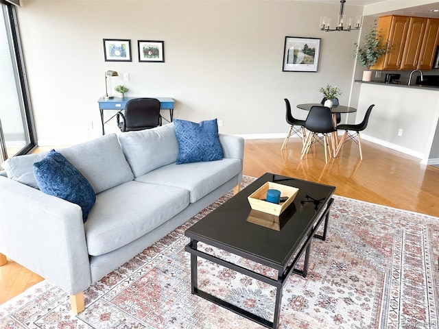 living room featuring light hardwood / wood-style flooring and a chandelier