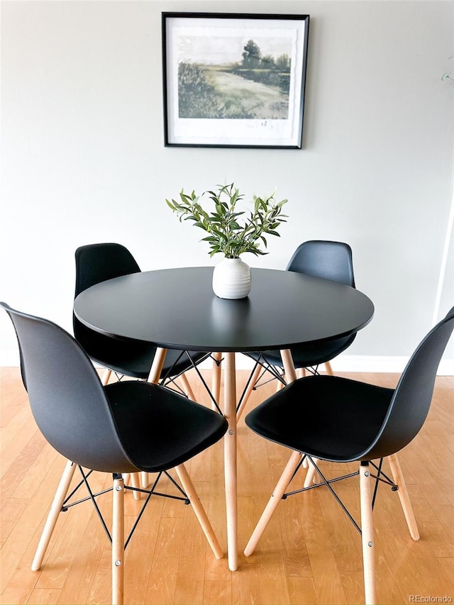 dining area with hardwood / wood-style flooring