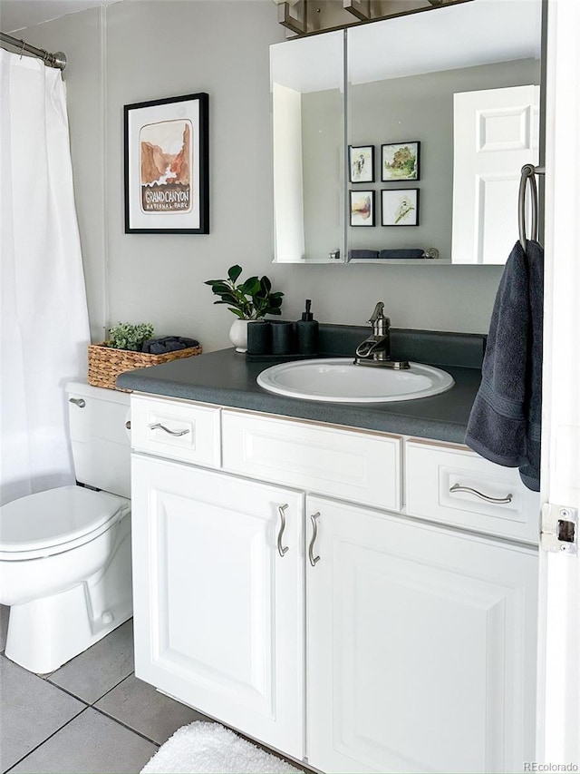 bathroom featuring vanity, toilet, and tile patterned floors