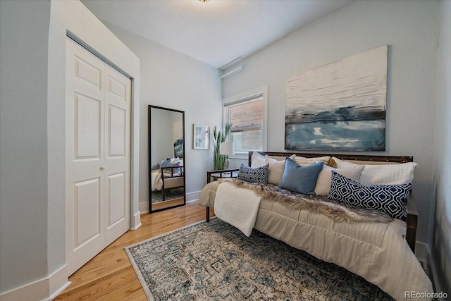 bedroom featuring hardwood / wood-style floors and a closet