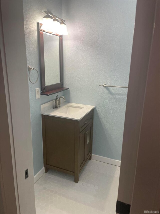 bathroom with tile patterned flooring and vanity