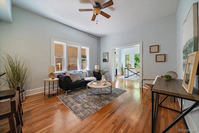 living room with light wood-type flooring and ceiling fan