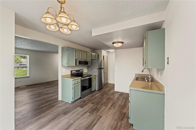 1344 Firefly Cir, Colorado Springs, CO 80916 - kitchen with appliances with stainless steel finishes, a textured ceiling, dark wood-type flooring, light countertops, and green cabinets