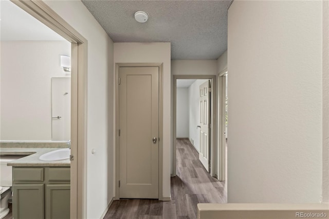 1344 Firefly Cir, Colorado Springs, CO 80916 - corridor featuring dark wood-style flooring and a textured ceiling