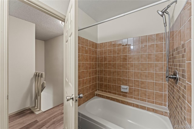 1344 Firefly Cir, Colorado Springs, CO 80916 - full bath featuring wood finished floors, shower / bath combination, and a textured ceiling