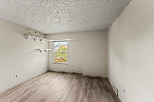 1344 Firefly Cir, Colorado Springs, CO 80916 - empty room featuring wood finished floors and a textured ceiling