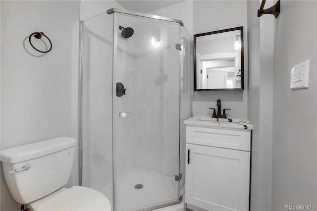 bathroom with vanity, an enclosed shower, and toilet