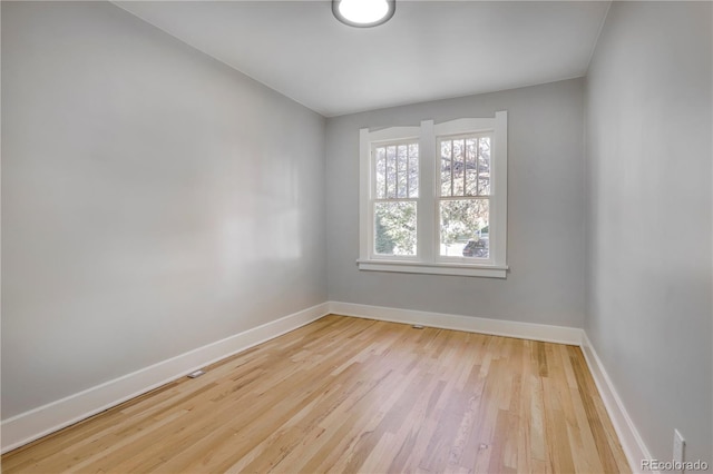 spare room with light hardwood / wood-style floors