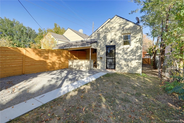 2103 S Lafayette St, Denver, CO 80210 - view of front facade with a fenced backyard and a patio area