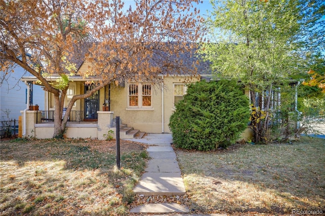 2103 S Lafayette St, Denver, CO 80210 - view of property hidden behind natural elements featuring stucco siding and covered porch