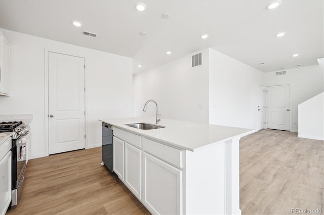 6636 N Nepal St, Aurora, CO 80019 - kitchen featuring a sink, stainless steel range with gas stovetop, dishwashing machine, light wood-style floors, and a center island with sink